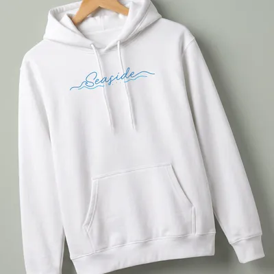 Cursive script design featuring the word Seaside over wave imagery in blue and white — printed on a unisex hoodie