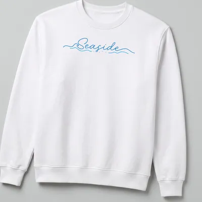 Cursive script design featuring the word Seaside over wave imagery in blue and white — printed on a unisex sweatshirt