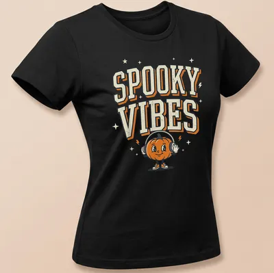 Cartoon pumpkin wearing headphones with Spooky Vibes text above — printed on a women's shirt