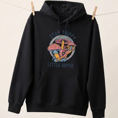 Colorful illustration of mushrooms with the text Stay Trippy Little Hippie above — printed on a unisex hoodie