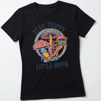 Colorful illustration of mushrooms with the text Stay Trippy Little Hippie above — printed on a women's shirt