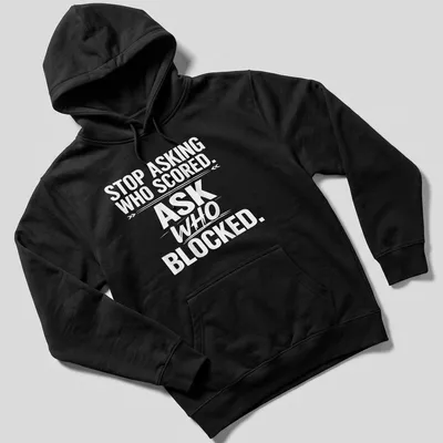 Bold text sports tee with the phrase 'STOP ASKING WHO SCORED. ASK WHO BLOCKED.' — printed on a unisex hoodie