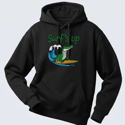 Cartoon alligator surfing with colorful text reading Surf's Up — printed on a unisex hoodie