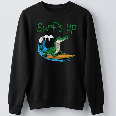 Cartoon alligator surfing with colorful text reading Surf's Up — printed on a unisex sweatshirt