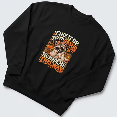 Vintage autumn-style T-shirt featuring a raccoon and playful text about Jesus. — printed on a unisex sweatshirt