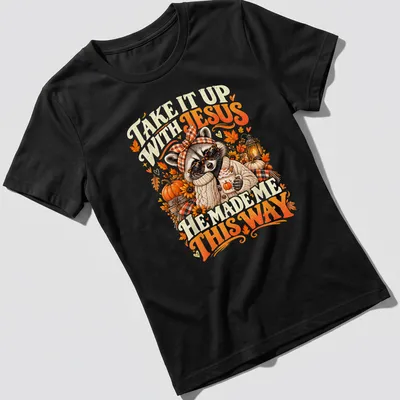Vintage autumn-style T-shirt featuring a raccoon and playful text about Jesus. — printed on a women's shirt