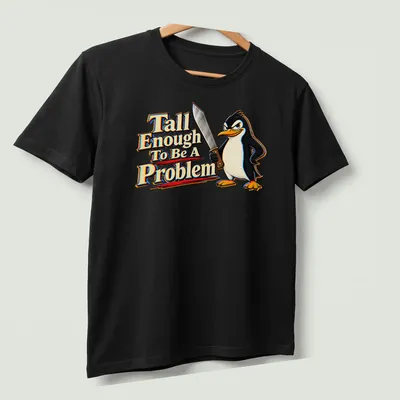 Cartoon penguin with humorous text about height in black, white, yellow, red, and blue. — printed on a unisex t-shirt (angled view)