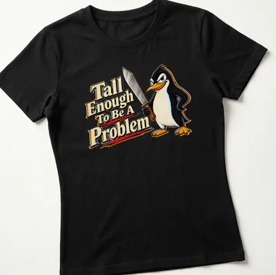 Cartoon penguin with humorous text about height in black, white, yellow, red, and blue. — printed on a women's shirt