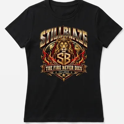 Bold typography t-shirt featuring a lion with the text 'STILLBLAZE THE FIRE NEVER DIES EST 2026' — printed on a women's shirt