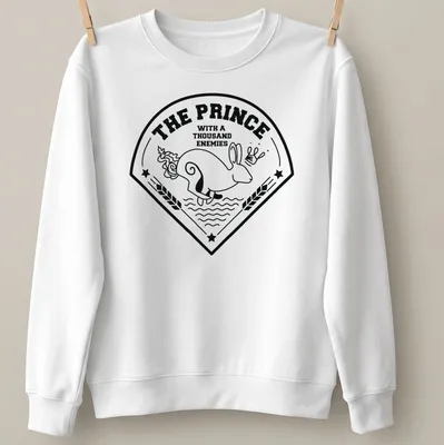 Bold line-art print of a rabbit with the text 'THE PRINCE WITH A THOUSAND ENEMIES' — printed on a unisex sweatshirt