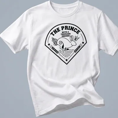 Bold line-art print of a rabbit with the text 'THE PRINCE WITH A THOUSAND ENEMIES' — printed on a unisex t-shirt