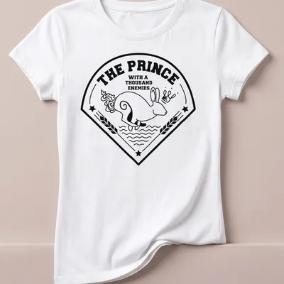 Bold line-art print of a rabbit with the text 'THE PRINCE WITH A THOUSAND ENEMIES' — printed on a women's shirt