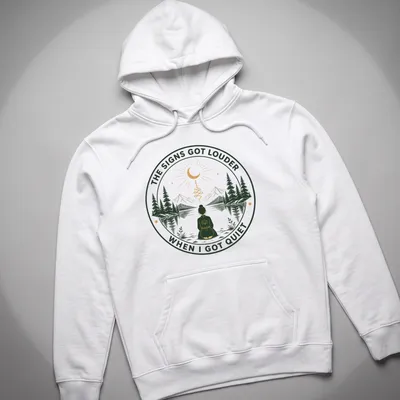 Meditation scene T-shirt with serene person and uplifting text in green and gold — printed on a unisex hoodie
