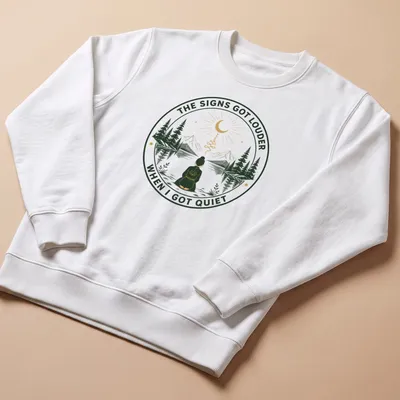 Meditation scene T-shirt with serene person and uplifting text in green and gold — printed on a unisex sweatshirt