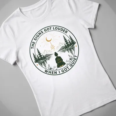 Meditation scene T-shirt with serene person and uplifting text in green and gold — printed on a women's shirt