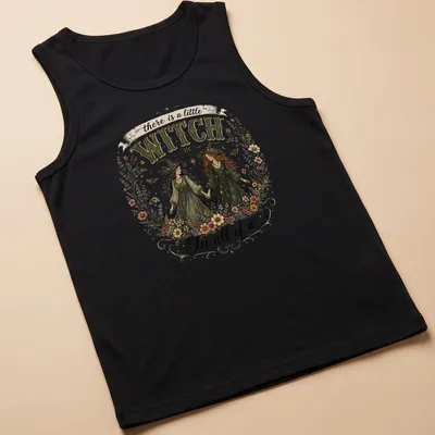 Two whimsical witches with the text 'there is a little WITCH In all of us' in vintage style — printed on a tank top