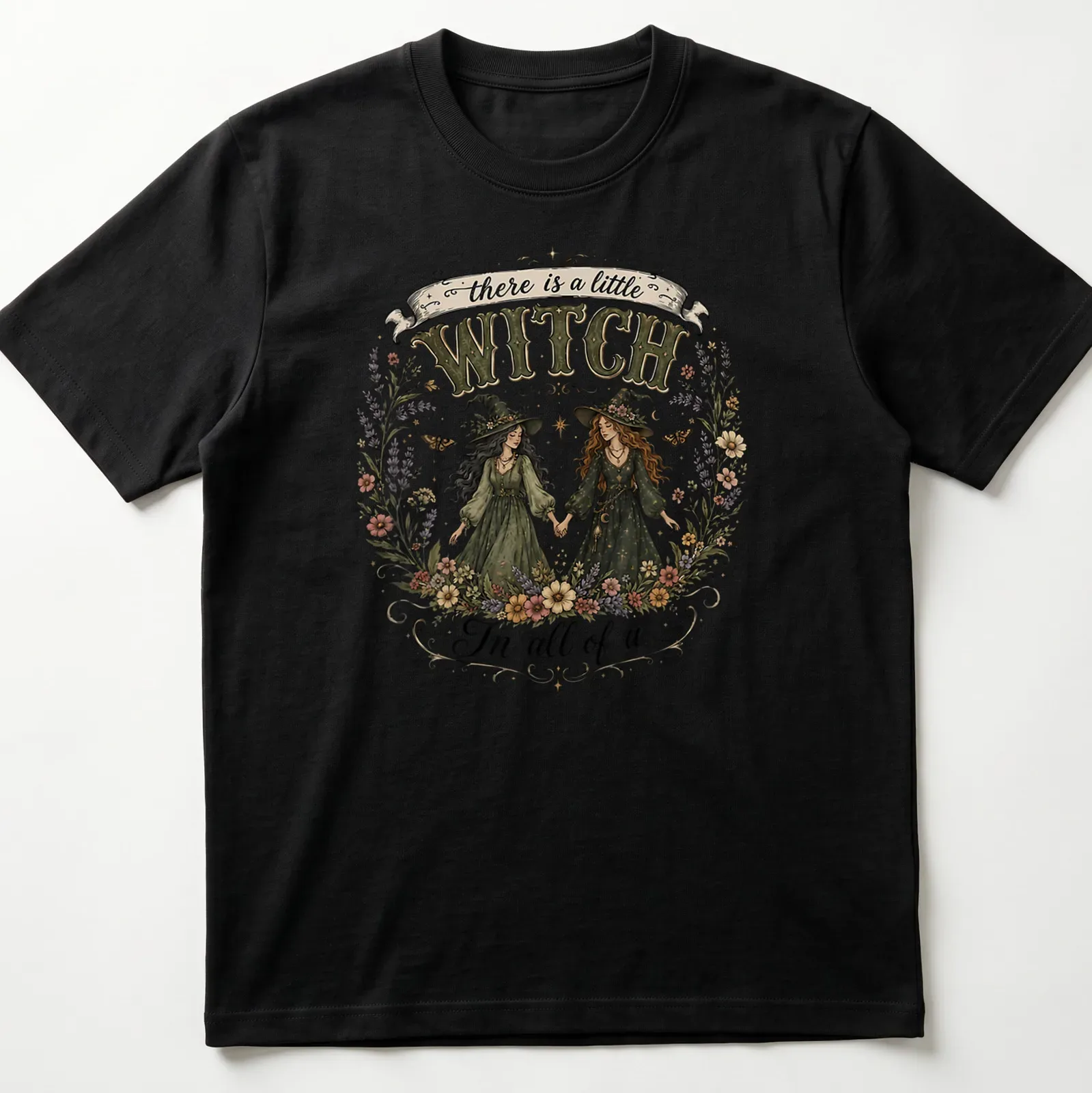 Two whimsical witches with the text 'there is a little WITCH In all of us' in vintage style — printed on a unisex t-shirt