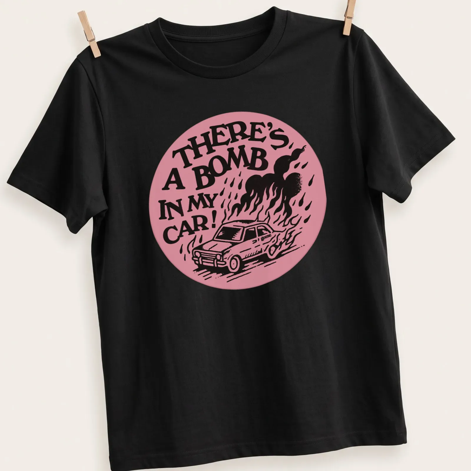 Bold graphic t-shirt featuring cartoon car with the text 'There's A Bomb In My Car!' — printed on a unisex t-shirt