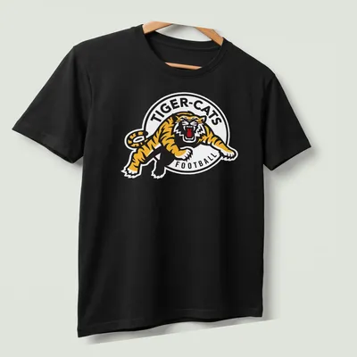 Hamilton Tiger-Cats logo t-shirt with bold black, yellow, and white graphics — printed on a unisex t-shirt (angled view)