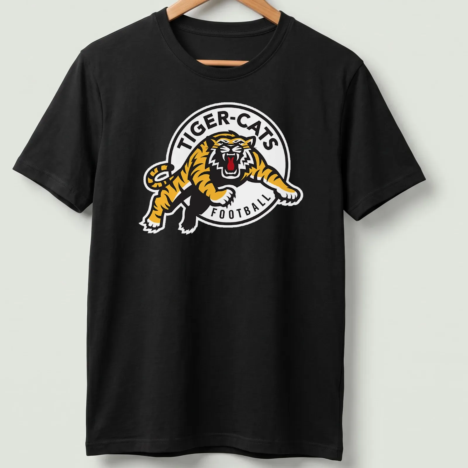 Hamilton Tiger-Cats logo t-shirt with bold black, yellow, and white graphics — printed on a unisex t-shirt