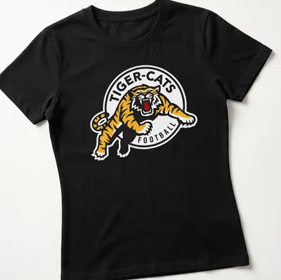 Hamilton Tiger-Cats logo t-shirt with bold black, yellow, and white graphics — printed on a women's shirt