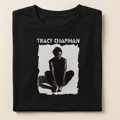 Black and white illustration of Tracy Chapman sitting with bold text below — printed on a women's shirt