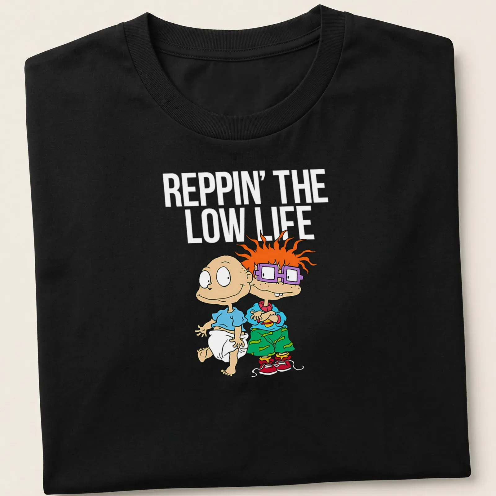 Cartoon T-shirt featuring two playful babies with joyful expressions — printed on a unisex t-shirt