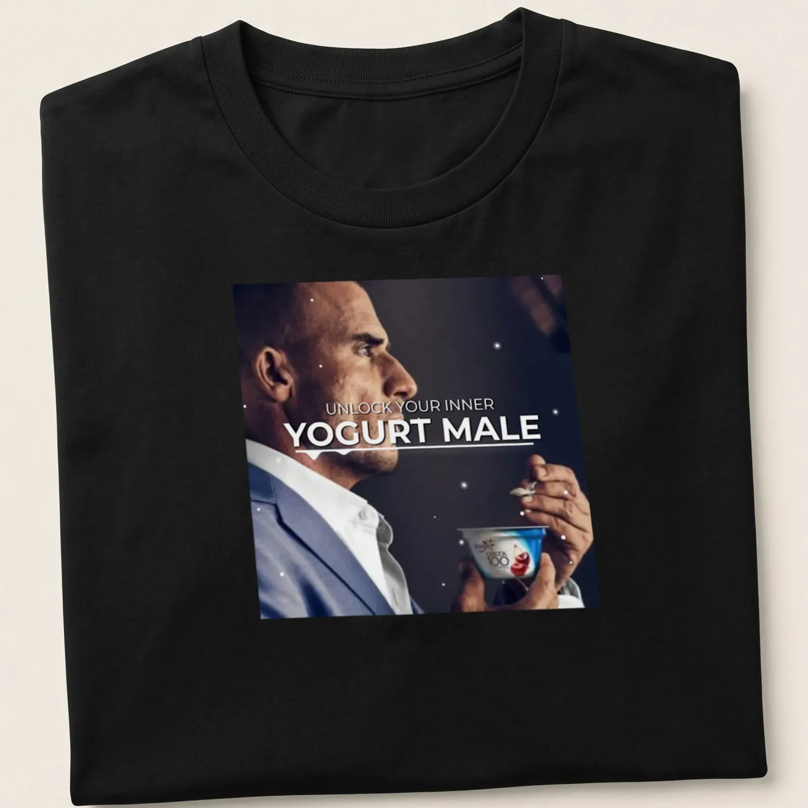 A man holds yogurt with the phrase 'Unlock Your Inner Yogurt Male' in a modern font. — printed on a unisex t-shirt
