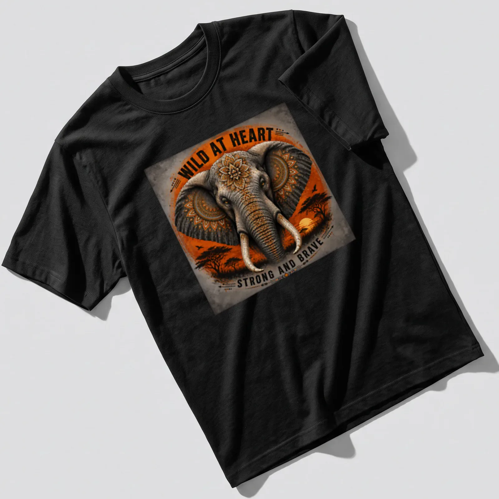 Detailed illustration of a strong and brave elephant with text about being wild at heart — printed on a unisex t-shirt