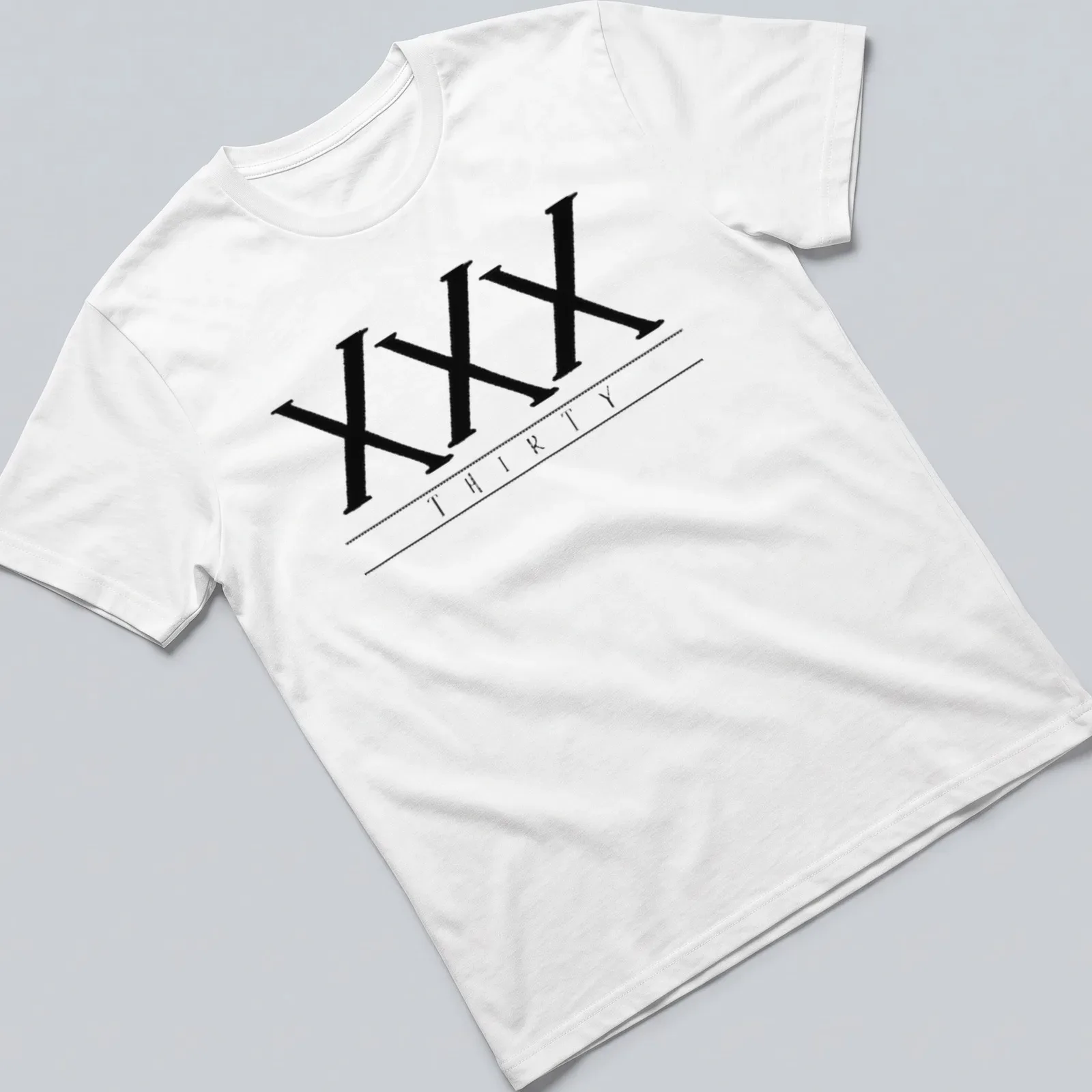 Black t-shirt featuring bold printed text of the Roman numerals XXX THIRTY — printed on a unisex t-shirt
