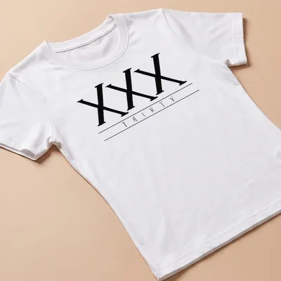 Black t-shirt featuring bold printed text of the Roman numerals XXX THIRTY — printed on a women's shirt