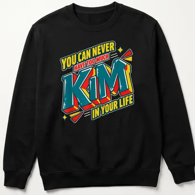 Bold 3D printed text reading 'You Can Never Have Too Much Kim In Your Life' in vibrant colors. — printed on a unisex sweatshirt