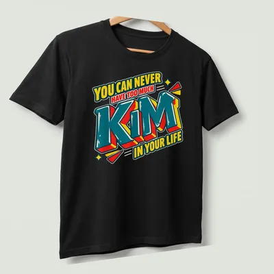 Bold 3D printed text reading 'You Can Never Have Too Much Kim In Your Life' in vibrant colors. — printed on a unisex t-shirt (angled view)