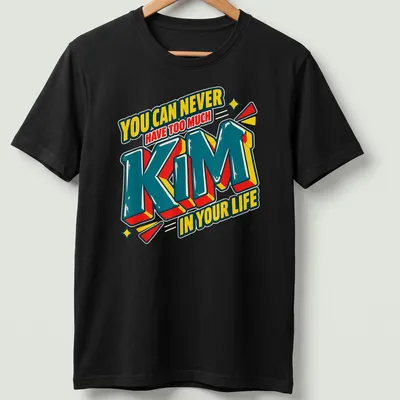 Bold 3D printed text reading 'You Can Never Have Too Much Kim In Your Life' in vibrant colors. — printed on a unisex t-shirt