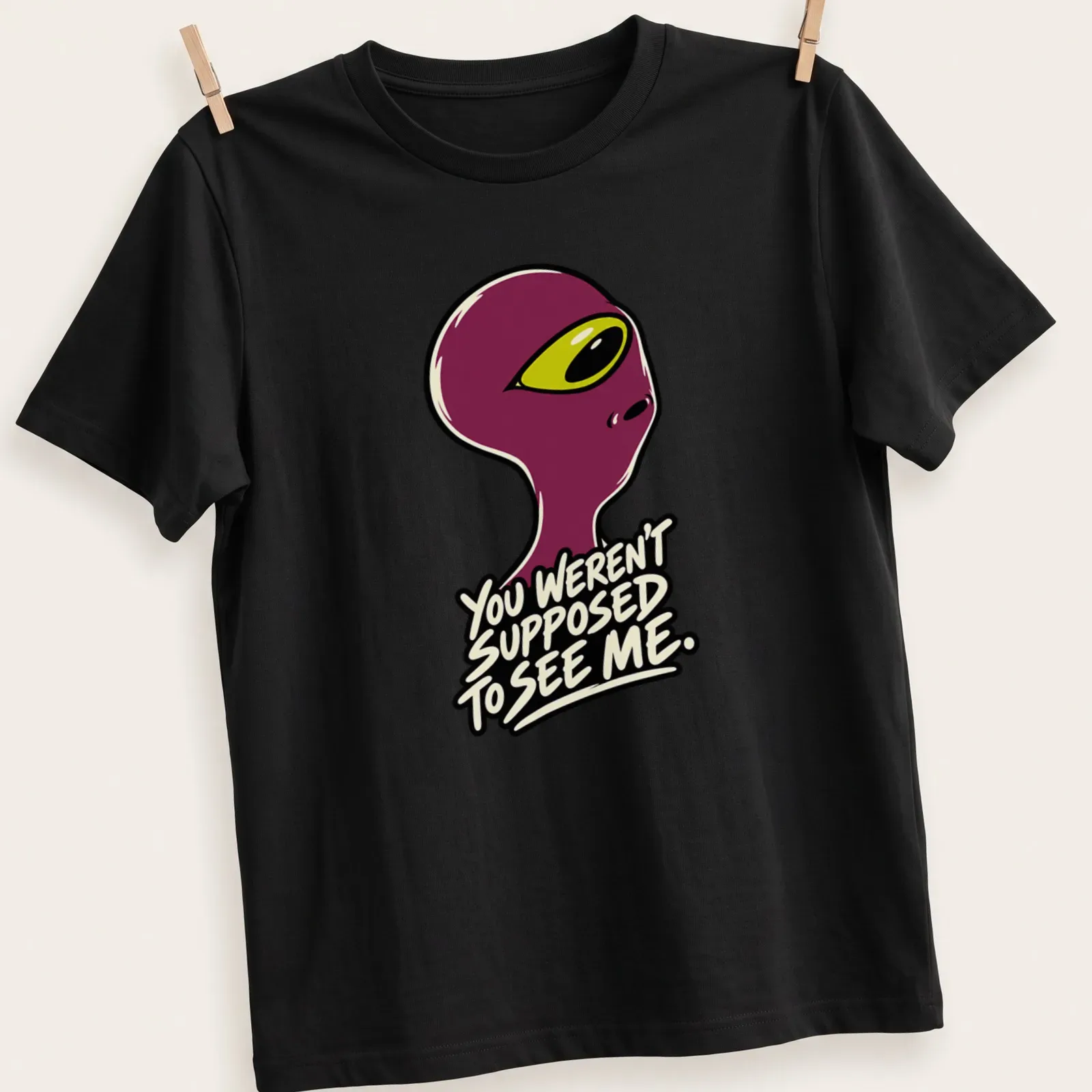 Cartoonish alien graphic with humorous text about being seen. — printed on a unisex t-shirt